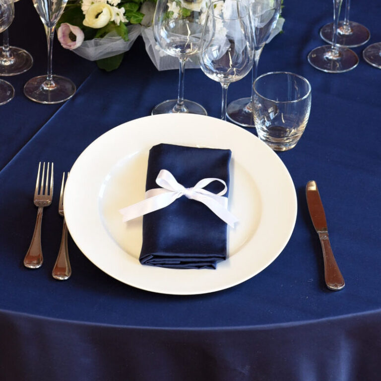 Dettaglio di una tavola apparecchiata con biancheria blu.